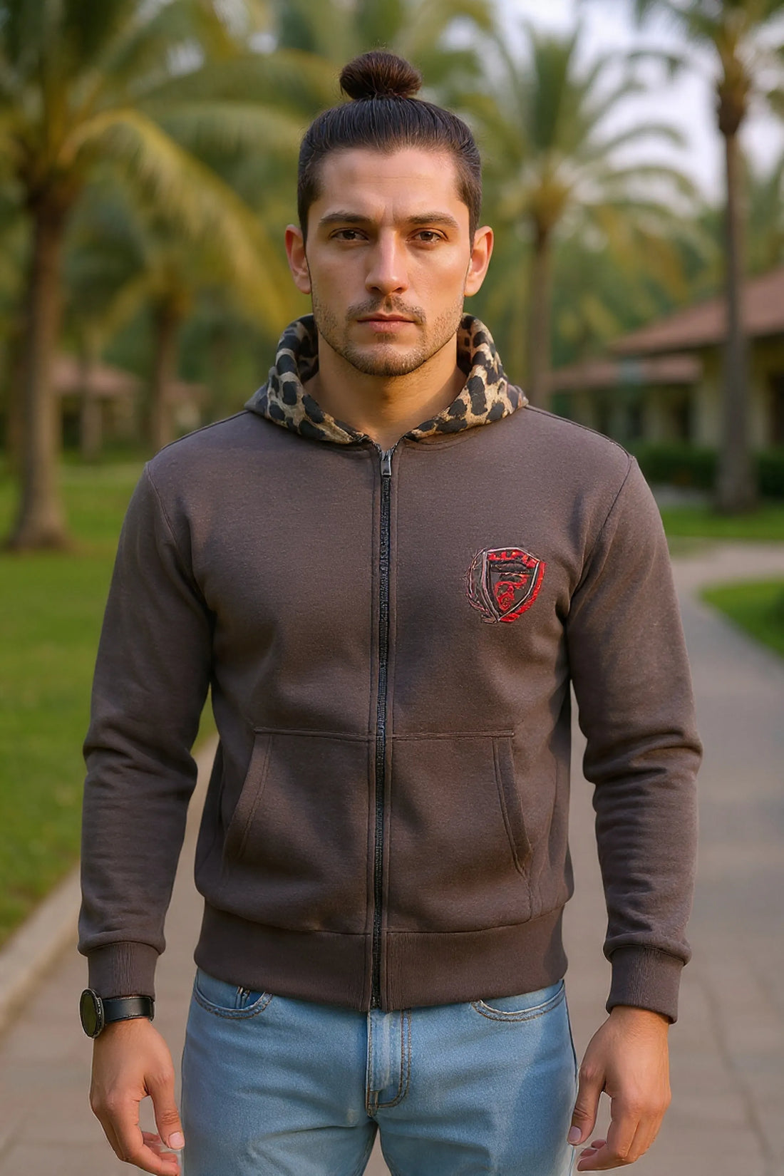 Woman wearing a dark gray hoodie with a logo in an autumn setting