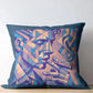 Decorative pillow with abstract face design on a wooden surface