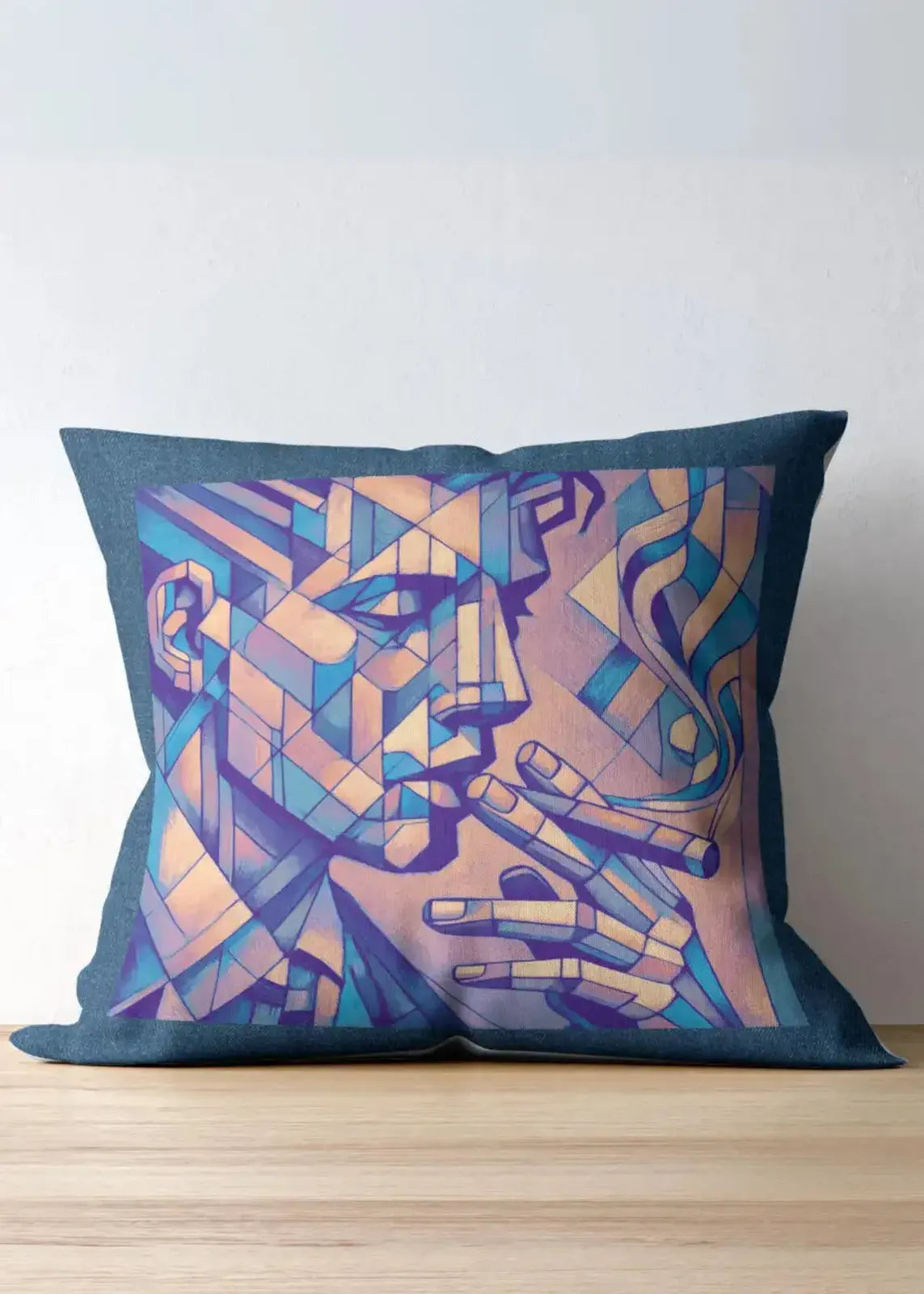 Decorative pillow with abstract face design on a wooden surface