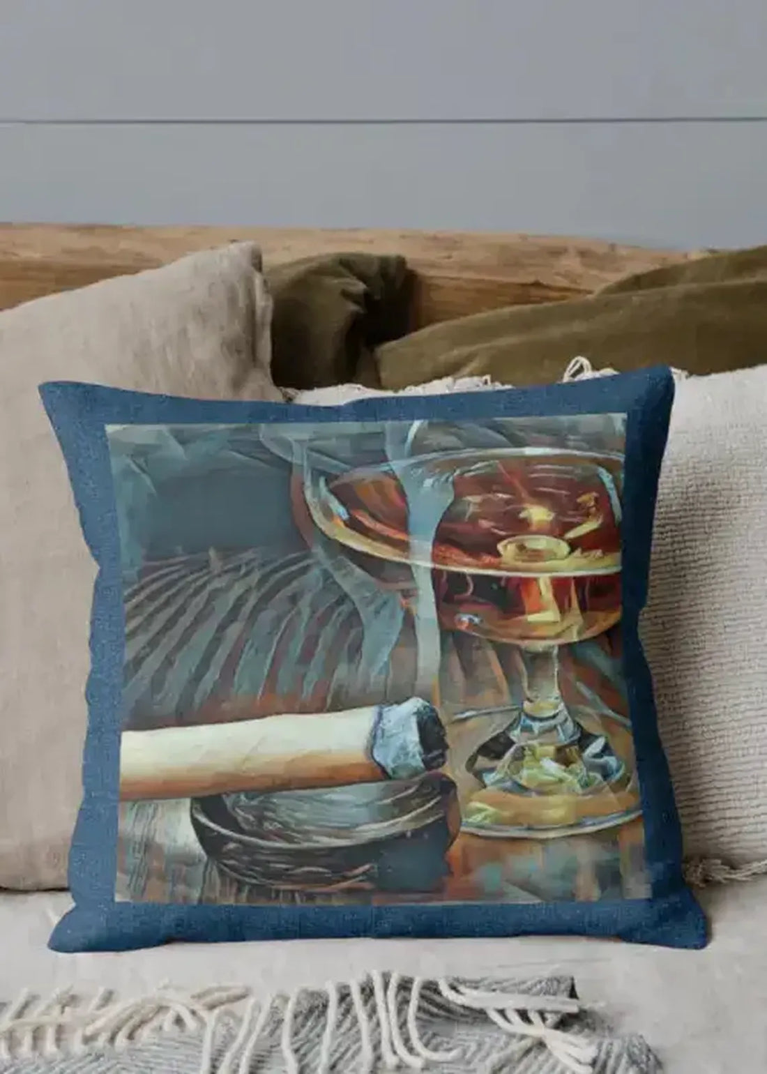 Decorative pillow with a glass of whiskey and a cigar on a couch.