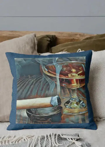 Decorative pillow with a glass of whiskey and a cigar on a couch.