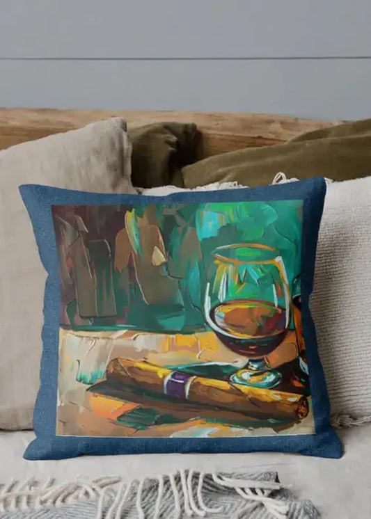 Decorative pillow with a painting of a glass of red wine on a couch.