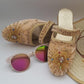 Cream color velvet mule shoes with beaded hand embroidery, displayed alongside sunglasses and a straw hat.
