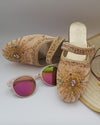 Cream color velvet mule shoes with beaded hand embroidery, displayed alongside sunglasses and a straw hat.