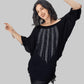Woman wearing a black sweater with silver embellishments on a white background