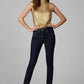 Woman wearing a gold top and dark jeans on a gray background