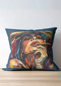 Decorative pillow with a colorful portrait of a person smoking on a wooden surface.