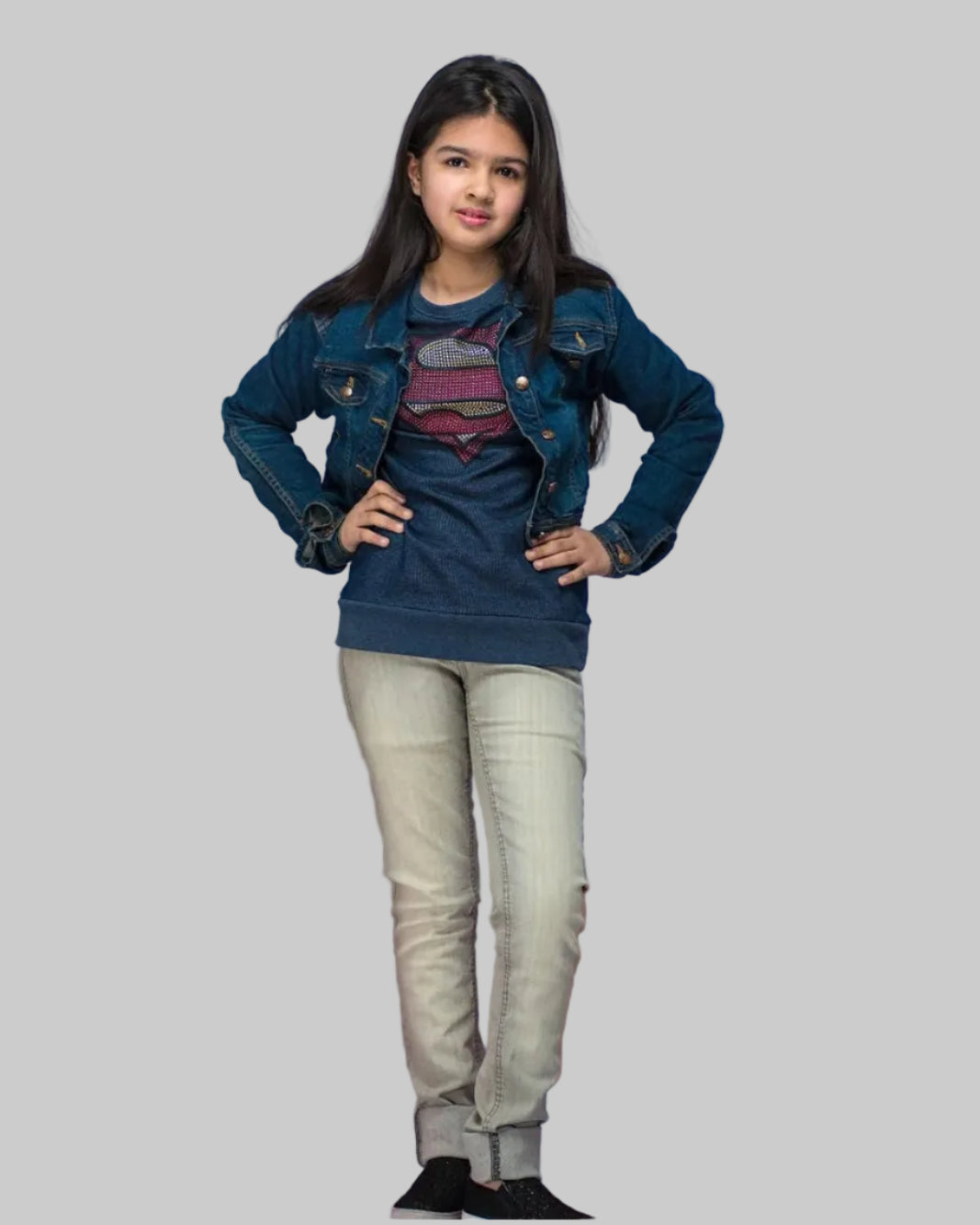 Person wearing a denim jacket and jeans standing on red and blue blocks against a light gray background