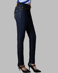 Dark blue jeans worn by a person on a gray background