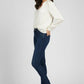 Woman wearing a white blouse and dark blue jeans on a white background