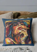 Colorful pillow with a stylized portrait of a person smoking a cigar on a couch.
