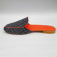 Slipper with checkered pattern and orange insole on a light gray background