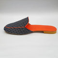 Slipper with checkered pattern and orange insole on a light gray background