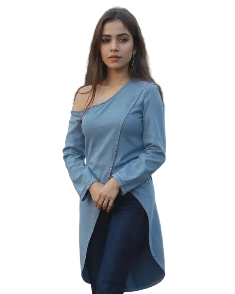 Woman wearing a blue off-shoulder top and dark jeans outdoors.