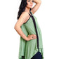Woman wearing a green sleeveless top with black trim on a white background