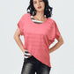 Woman wearing a pink top and black pants on a white background