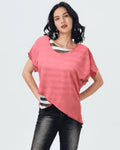Woman wearing a pink top and black pants on a white background