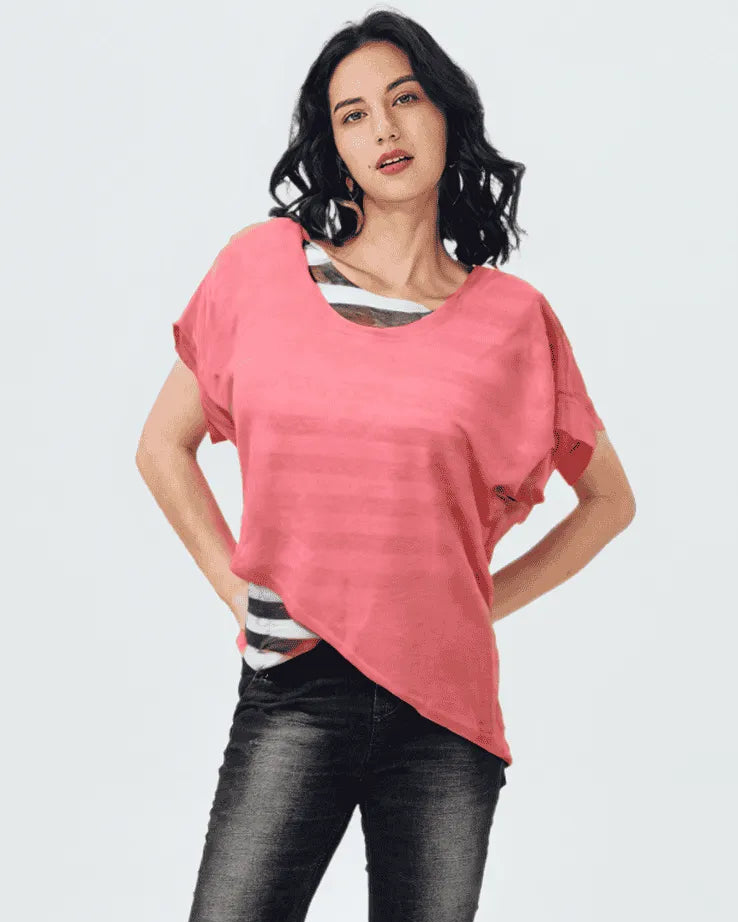 Woman wearing a pink top and black pants on a white background