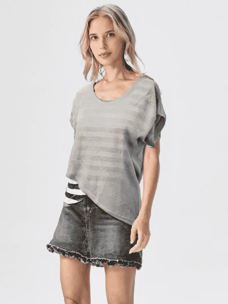 Woman wearing a gray t-shirt with a white and black striped pattern on a white background