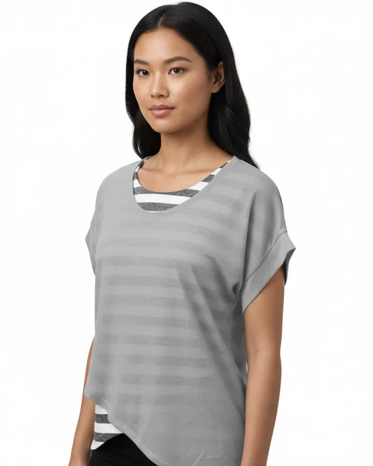 Woman wearing a gray t-shirt with a white and black striped pattern on a white background