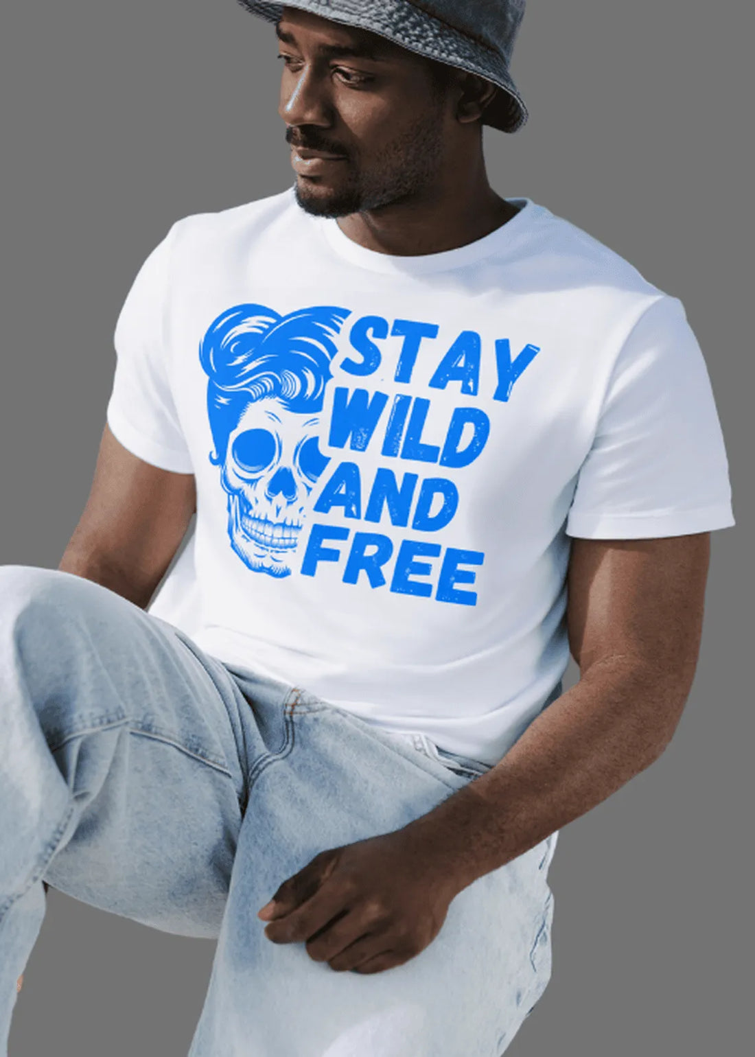 Person wearing a white t-shirt with a blue graphic and text 'Stay Wild and Free' on a gray background