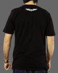 Person wearing a black t-shirt with a logo on the back against a gray background