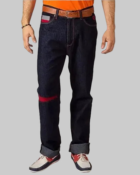 Person wearing dark blue jeans with red accents and a brown belt, standing against a white background. Brand 'Element Jeans Co.