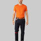 Man wearing an orange t-shirt and dark jeans on a white background