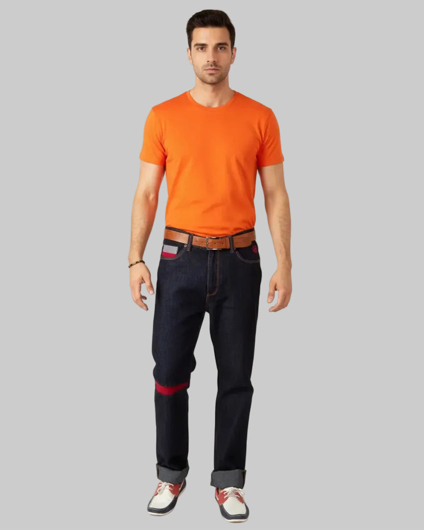 Person wearing dark blue jeans with red accents and a brown belt, standing against a white background. Brand 'Element Jeans Co.