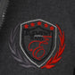 Close-up of a dark gray jacket with an embroidered logo featuring stars and flames.