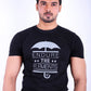 Man wearing a black t-shirt with 'Endure the Elements' graphic on a white background