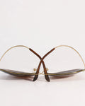 Pair of eyeglasses with gold frame on a white background