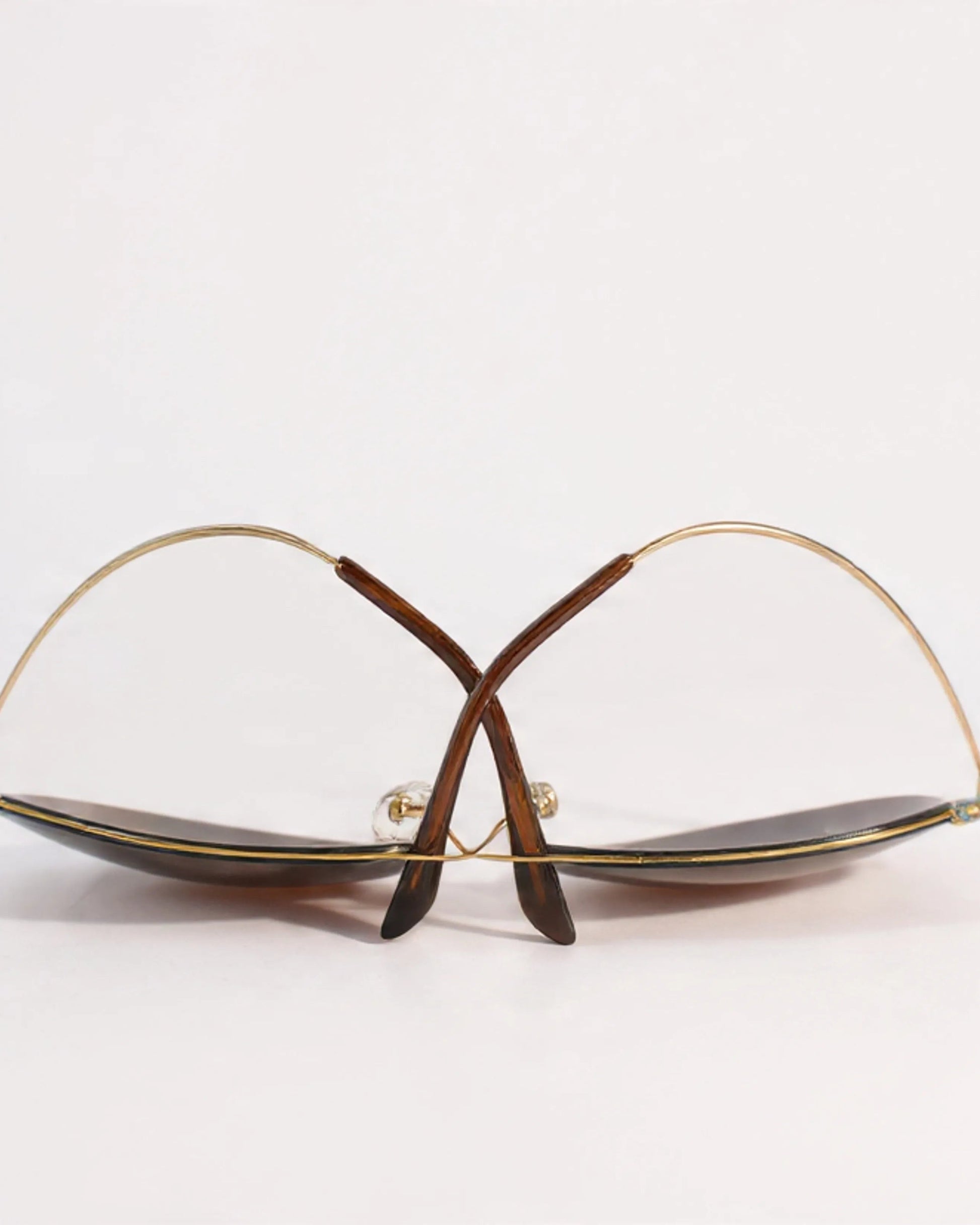 Pair of eyeglasses with gold frame on a white background