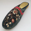 Decorative slipper with floral embroidery on a white background