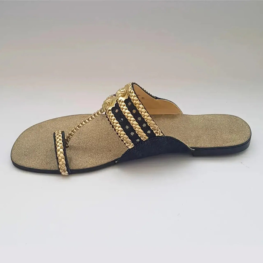 Beige sandal with gold chain design on a white background