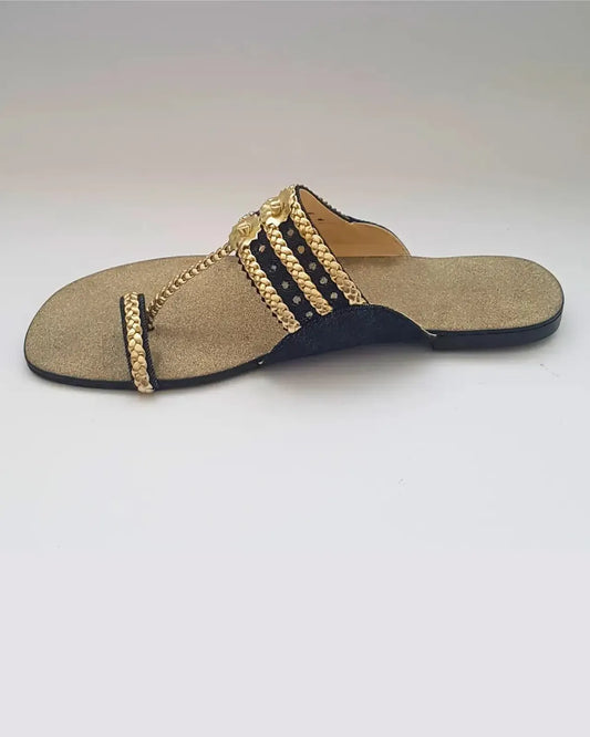 Beige sandal with gold chain design on a white background