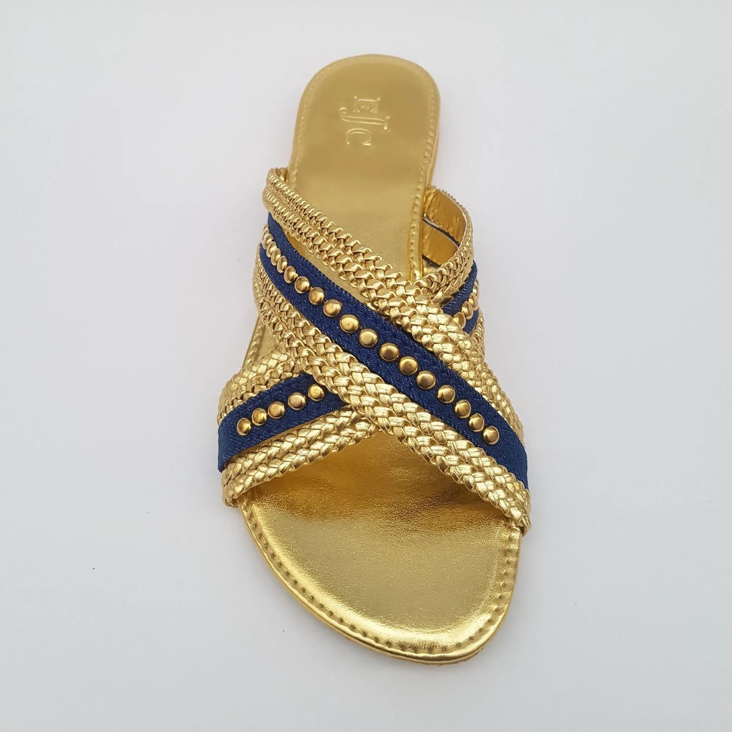 Gold sandal with blue strap on a light gray background