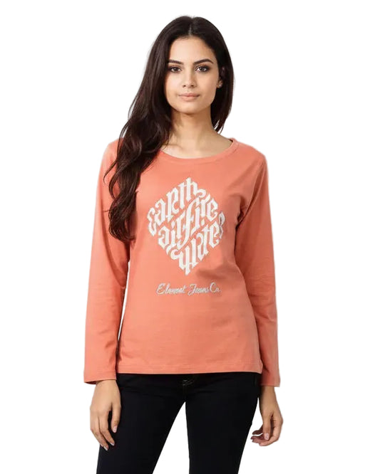 Woman wearing a coral sweatshirt with text on a plain background
