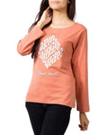Person wearing a peach-colored long-sleeve shirt with white text on a gray background