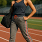 Woman in athletic wear standing on a track field