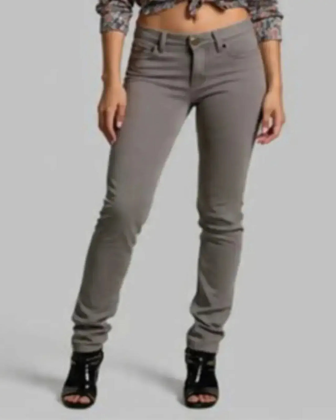 Person wearing gray pants on a plain background