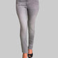 Gray jeans worn by a person on a gray background