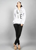 Person wearing a white hoodie with 'LOVE' printed on it against a gray background