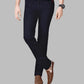 Person wearing black pants with a brown belt and shoes on a gray background