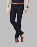 Person wearing black pants with a brown belt and shoes on a gray background