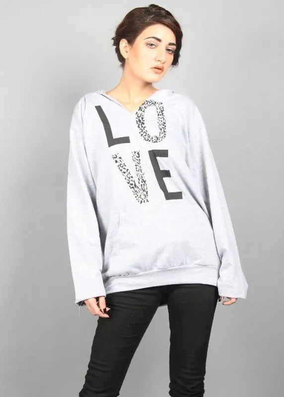 Person wearing a gray hoodie with 'LOVE' printed on it against a gray background