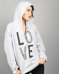 Person wearing a gray hoodie with 'LOVE' printed on it against a gray background