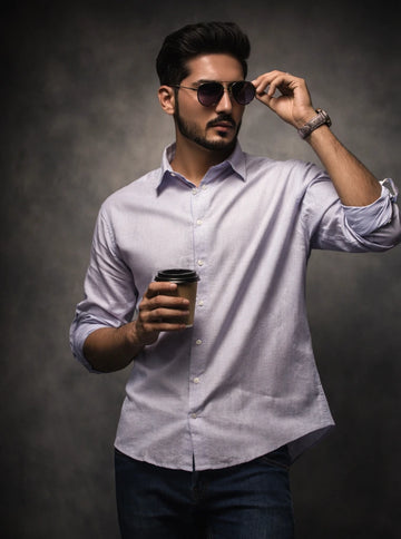 Man wearing sunglasses and holding a coffee cup against a dark background