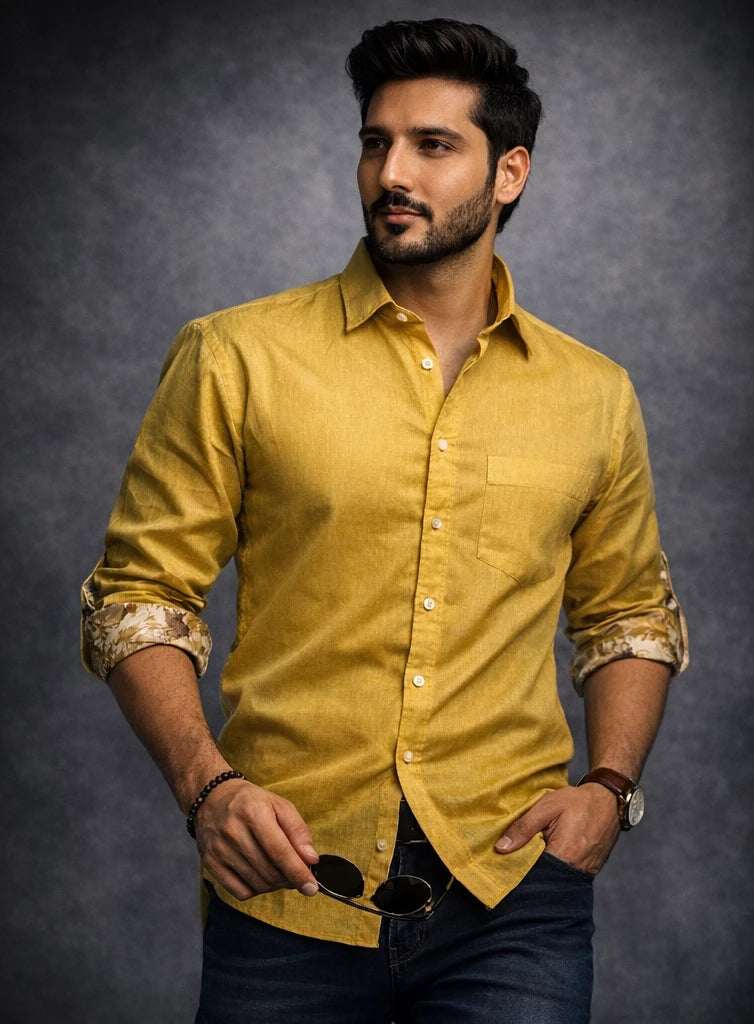 Man in a yellow shirt with a dark background