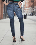 Person wearing blue jeans on a city street